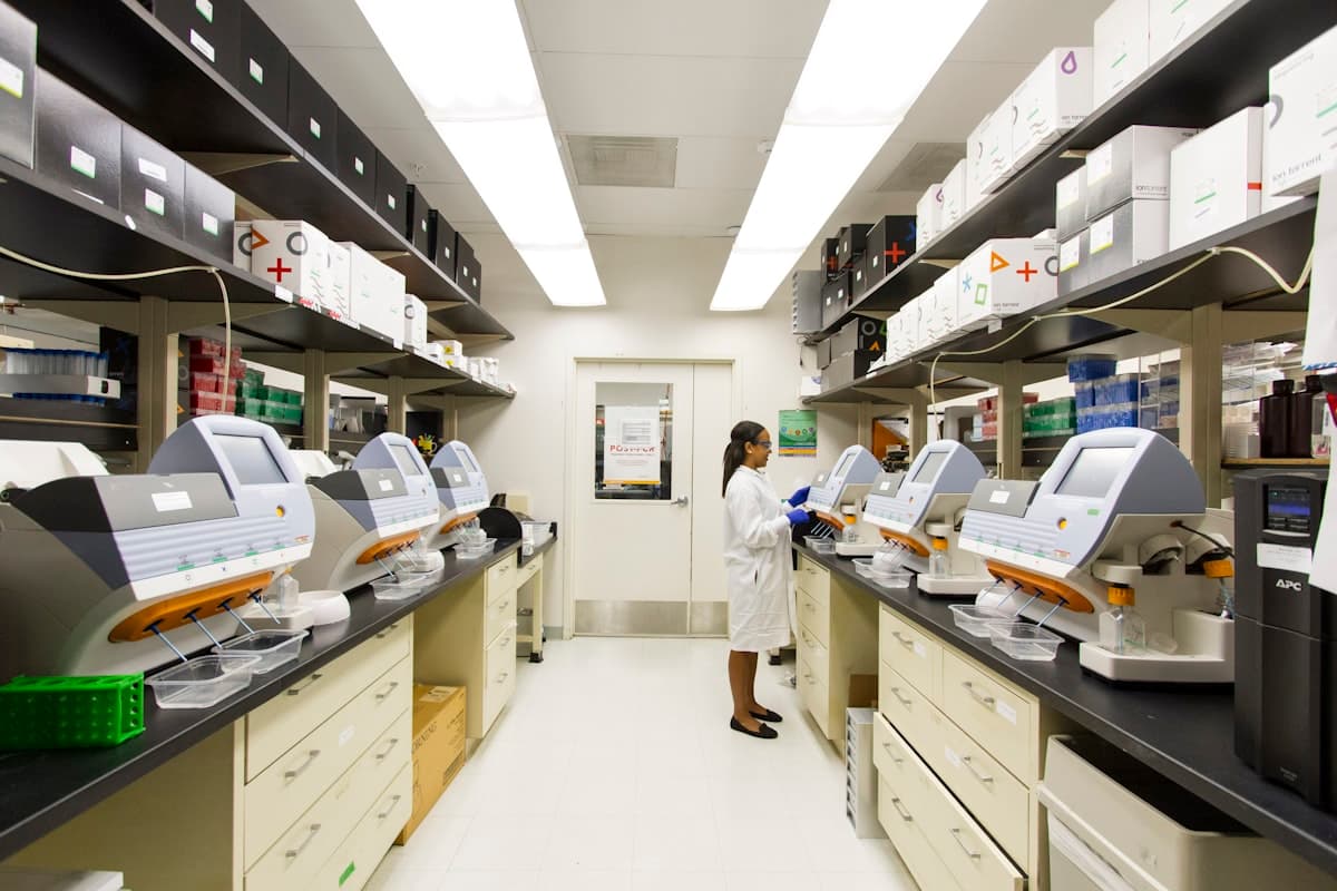 Scientist working among diagnostic instruments in a clean lab