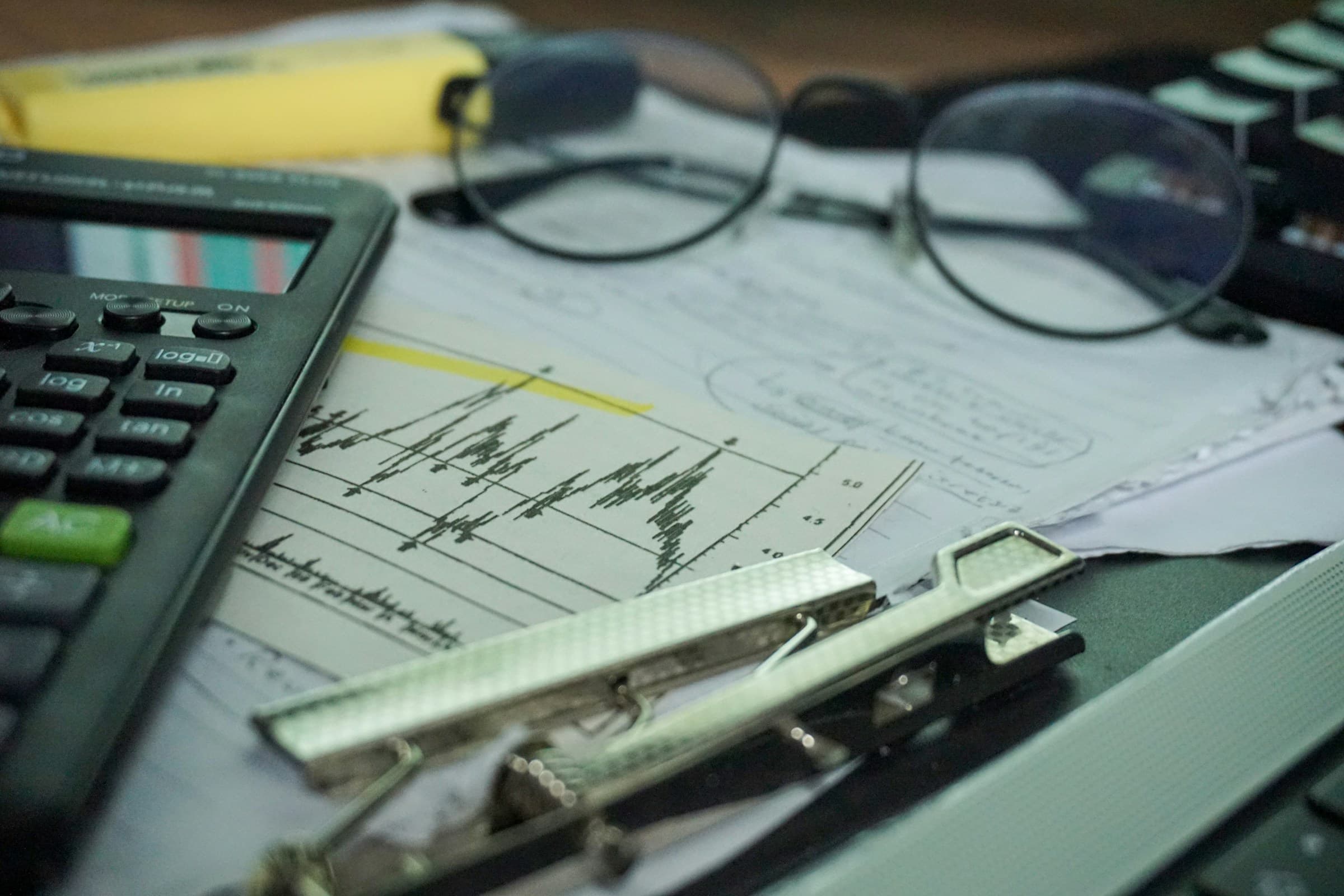 Calculator and financial charts on a desk