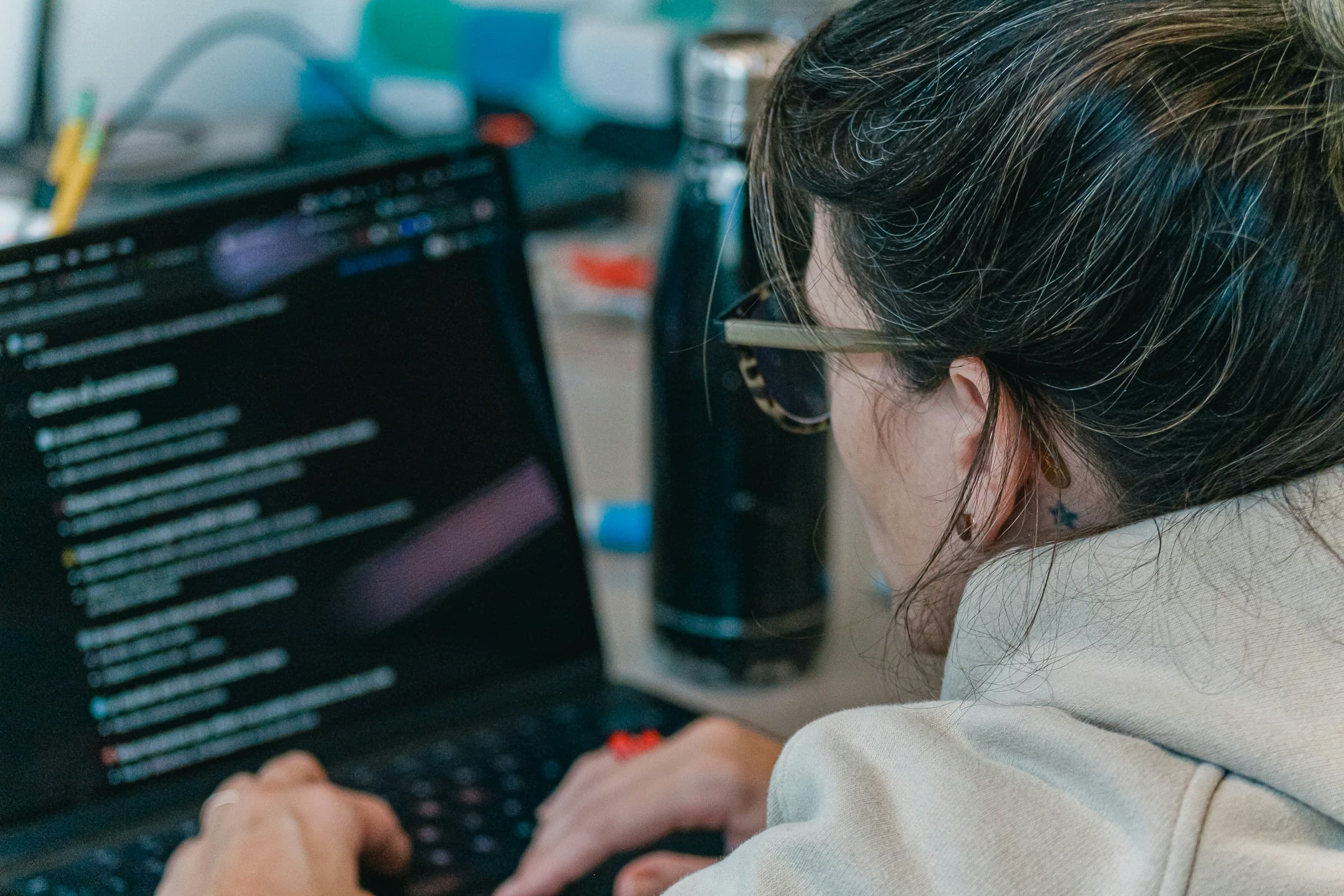 Developer working at a laptop screen of code