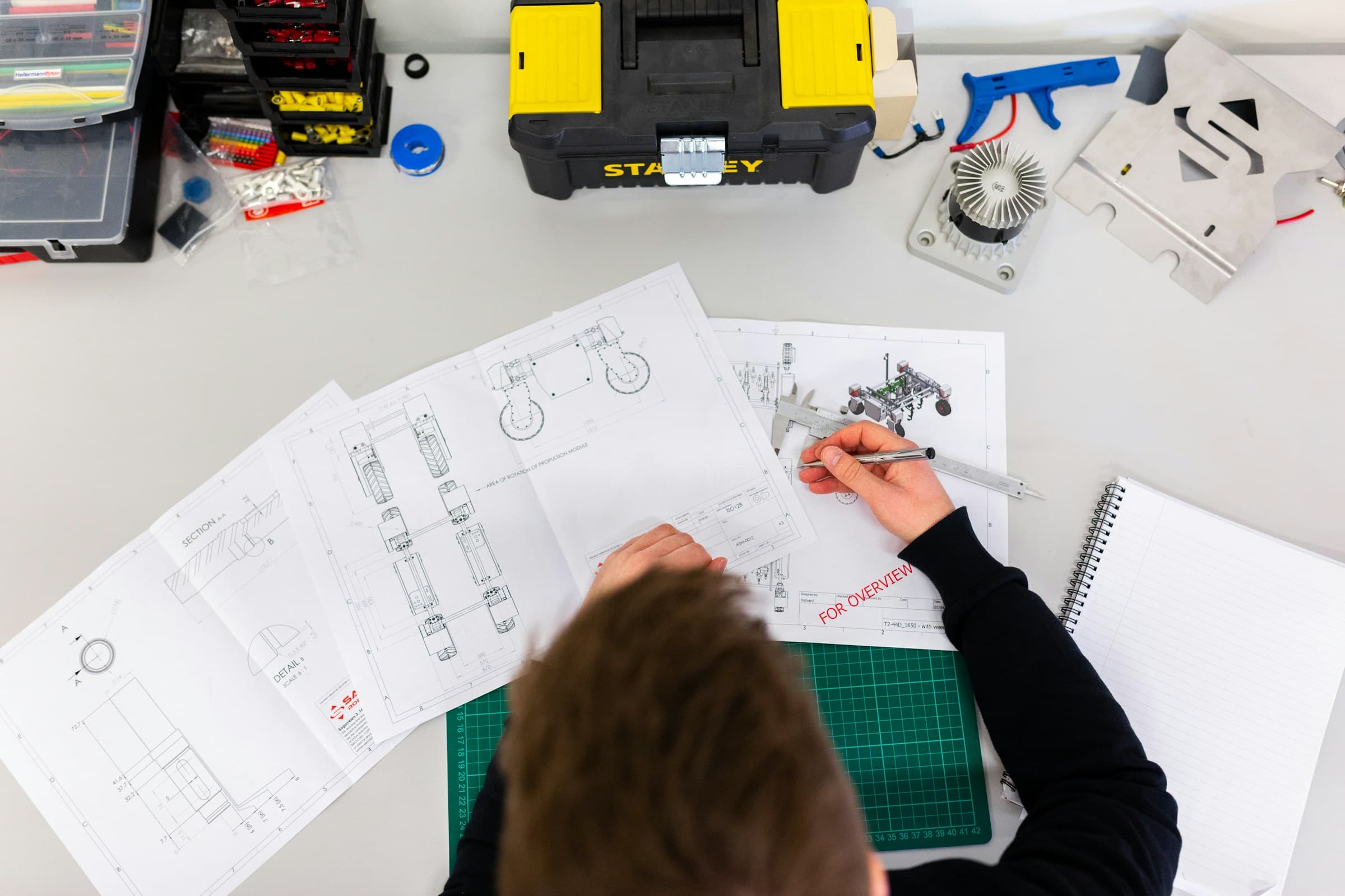 Engineer reviewing drawings of a mechanical prototype