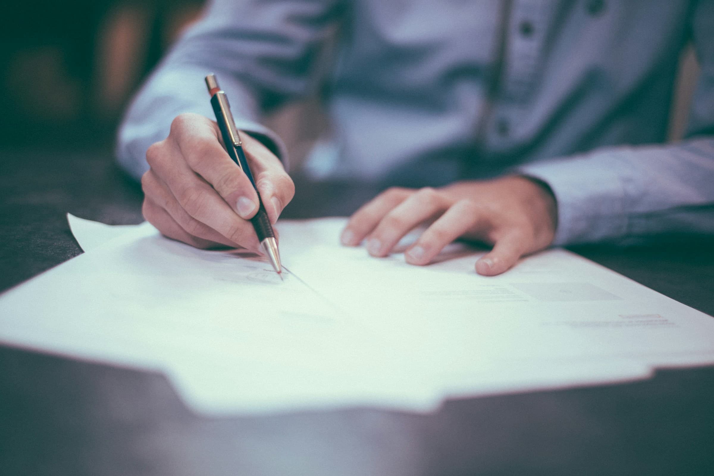 Signing a document at a table